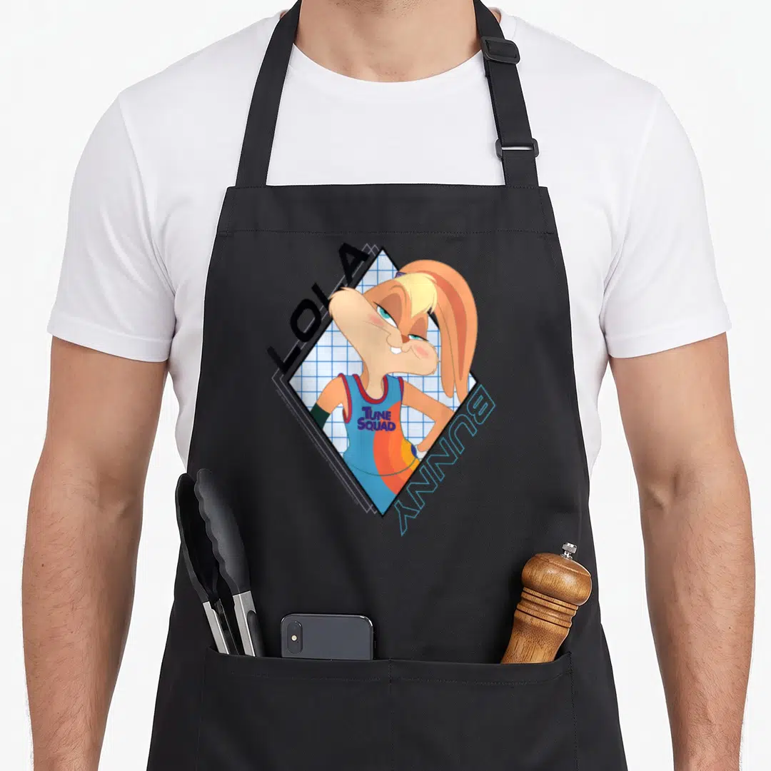 Space bunny apron - Lola Bunny in blue diamond grid with Tune Squad jersey and diagonal LOLA BUNNY text — shown on a black cotton canvas apron against a white background