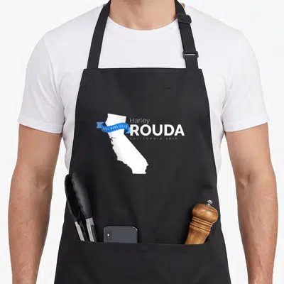 Rouda midterm apron - White California map with blue ribbon reading BLUE WAVE 2018 next to Harley ROUDA text — shown on a black cotton canvas apron against a white background