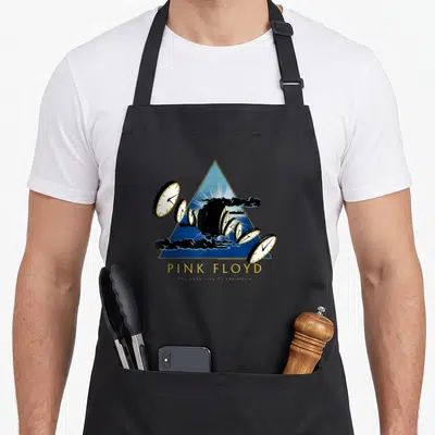 50th novelty apron - Blue triangle with melting clocks and black clouds below Pink Floyd text — shown on a black cotton canvas apron against a white background