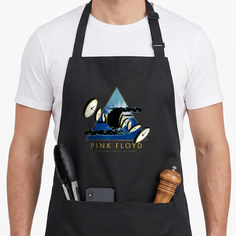 50th novelty apron - Blue triangle with melting clocks and black clouds below Pink Floyd text — shown on a black cotton canvas apron against a white background