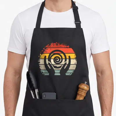 Kiln pottery ceramic apron - Grey spiral held by two hands inside distressed red orange yellow beige teal striped circle — shown on a black cotton canvas apron against a white background