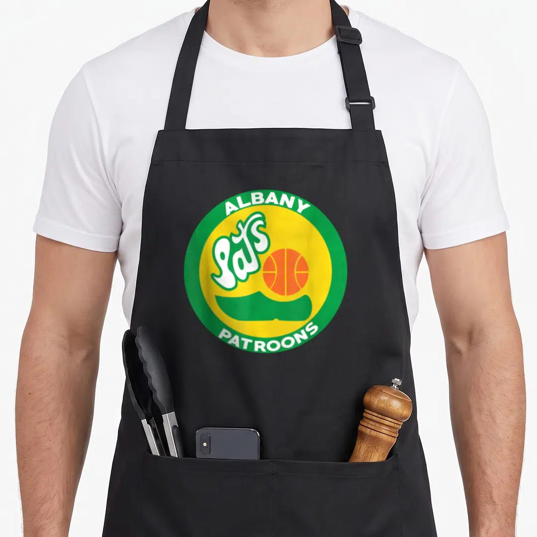 Albany albanian apron - Circular Albany Pats Patroons basketball logo with green border yellow center and script — shown on a black cotton canvas apron against a white background