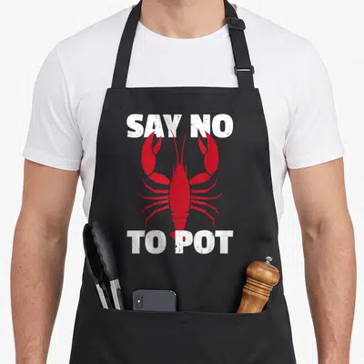 Cute pot lobster apron - Red lobster graphic with white text SAY NO TO POT above and below — shown on a black cotton canvas apron against a white background