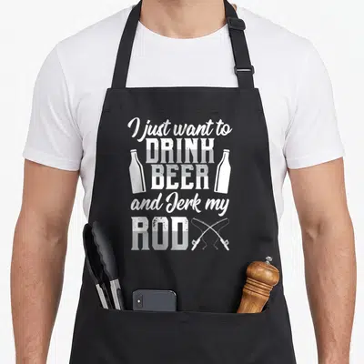 Beer fishing aprons - White stacked text I just want to drink beer and jerk my rod flanked by bottles and crossed rods — shown on a black cotton canvas apron against a white background
