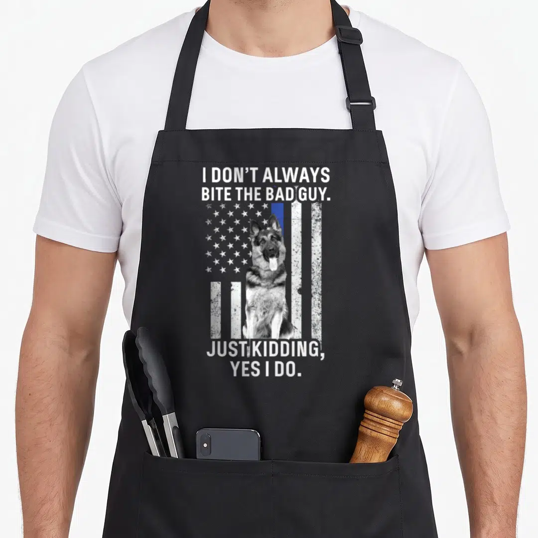 Police german apron - German Shepherd sitting before distressed flag with blue stripe and white text — shown on a black cotton canvas apron against a white background