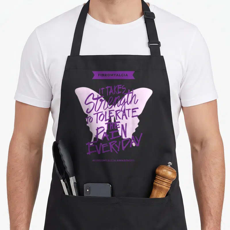 Fibromyalgia everyday apron - Purple ribbon and butterfly with text about tolerating pain — shown on a black cotton canvas apron against a white background