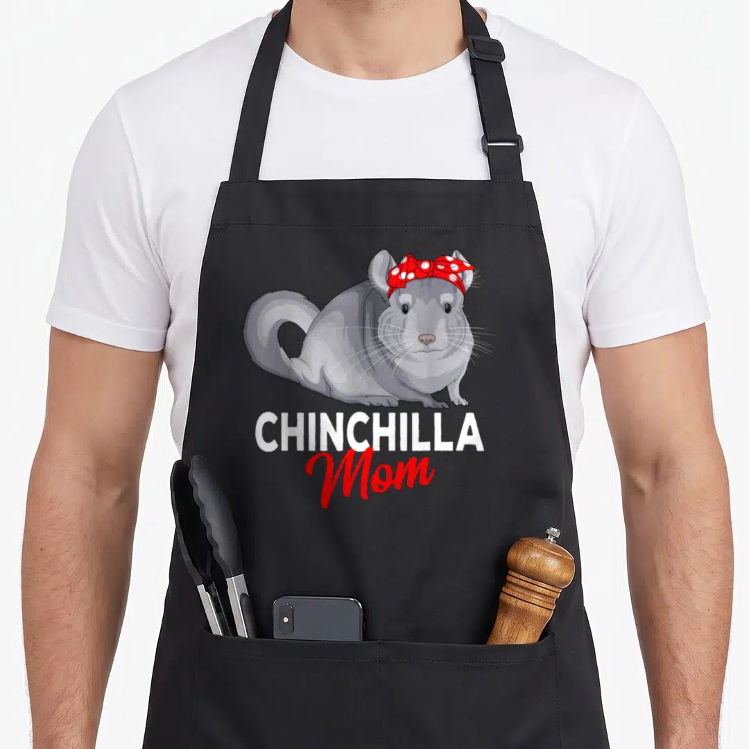 Funny chinchilla mother's day aprons - Cartoon grey chinchilla with red bow above white and red CHINCHILLA Mom text — shown on a black cotton canvas apron against a white background