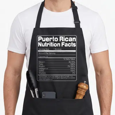 Nutrition rican apron - White nutrition facts label listing 1 Boricua serving size, 100% Pride, Rhythm, and Sofrito — shown on a black cotton canvas apron against a white background