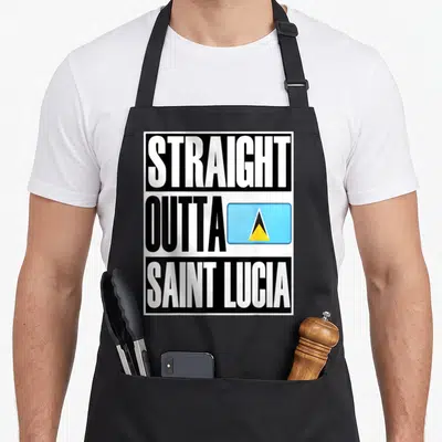 Outta saint lucia apron - Stacked STRAIGHT OUTTA SAINT LUCIA text with blue yellow and black flag icon — shown on a black cotton canvas apron against a white background