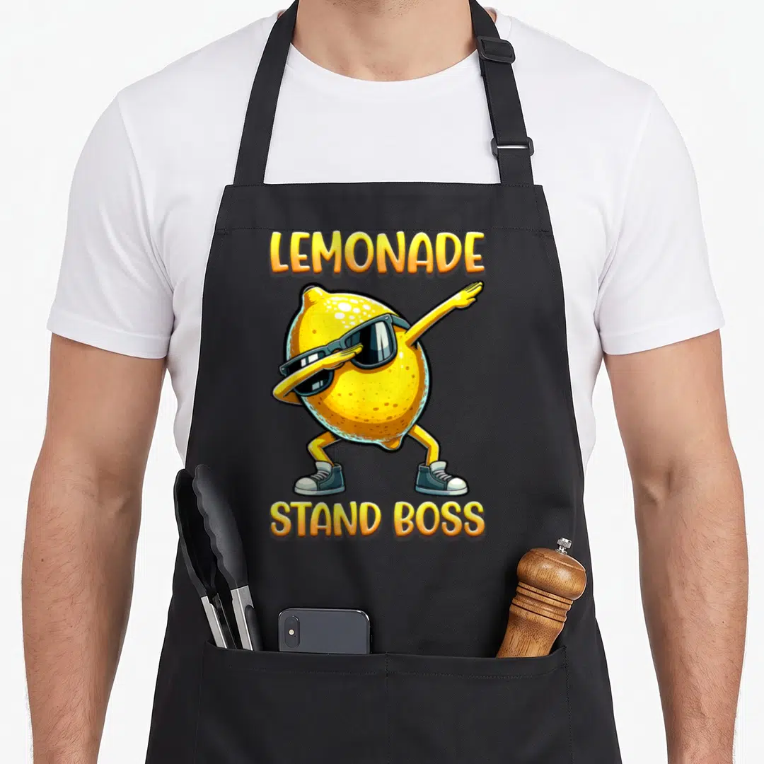 Summer lemonade apron - Cartoon lemon wearing sunglasses and sneakers with LEMONADE STAND BOSS text — shown on a black cotton canvas apron against a white background
