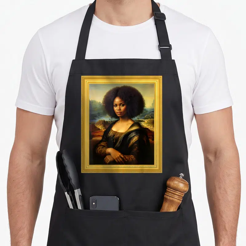 Mona african apron - Realistic portrait of a woman with an afro inside an ornate gold frame with a landscape background — shown on a black cotton canvas apron against a white background