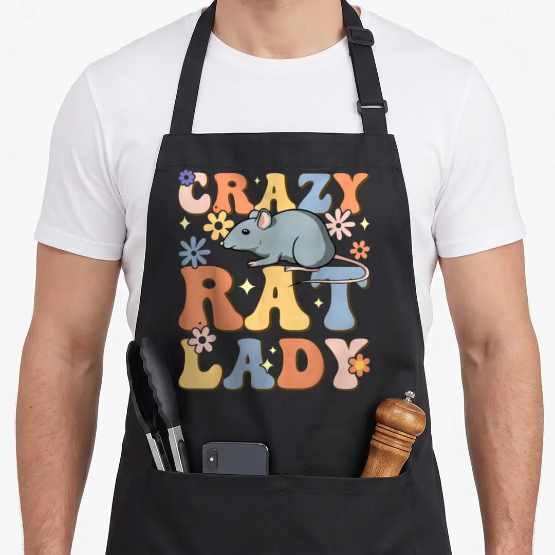 Rat groovy pet apron - Cartoon grey rat over vertical CRAZY RAT LADY text with colorful flowers and stars — shown on a black cotton canvas apron against a white background