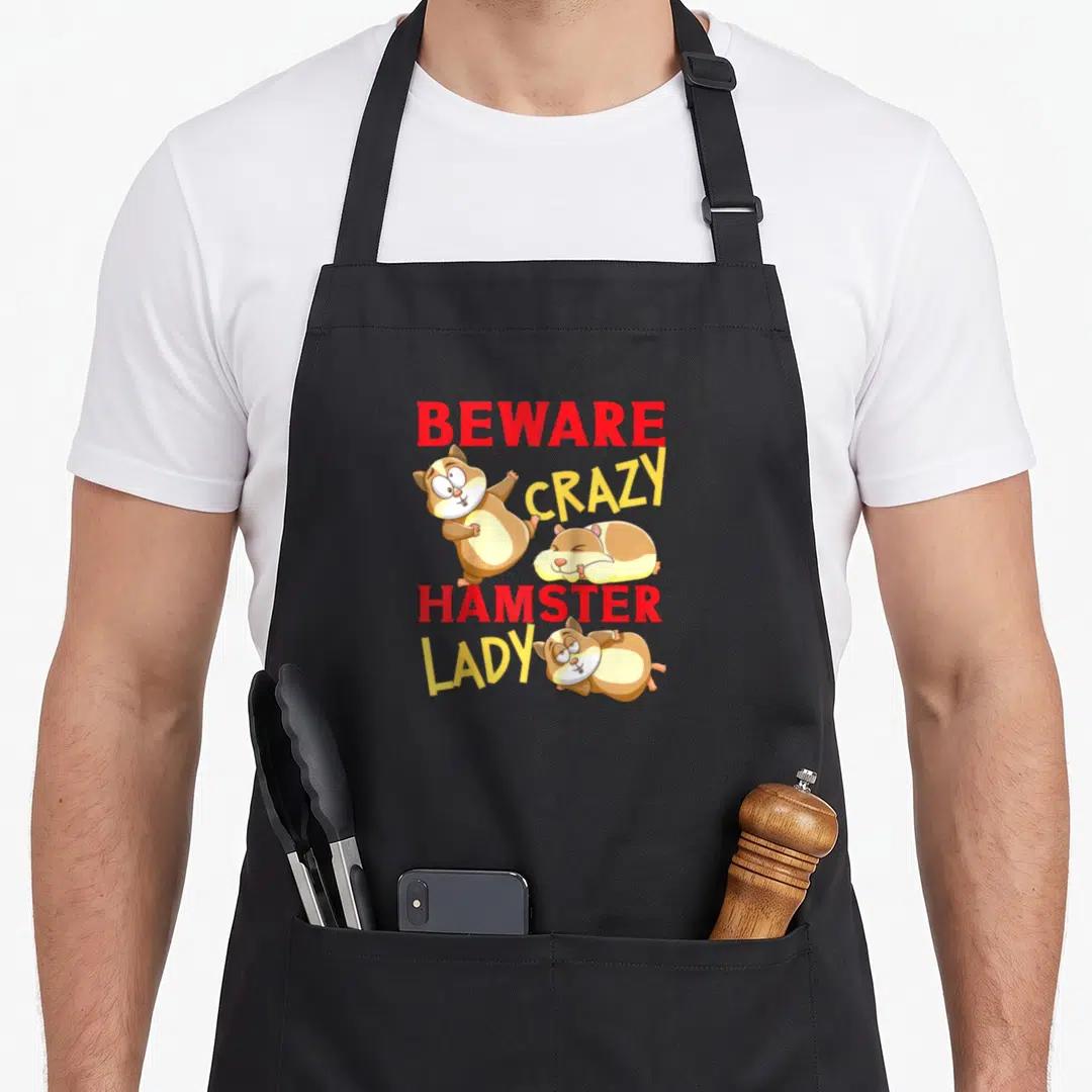 Hamster baseball apron - Stacked Beware Crazy Hamster Lady text with three cartoon hamsters in red, yellow, and brown — shown on a black cotton canvas apron against a white background