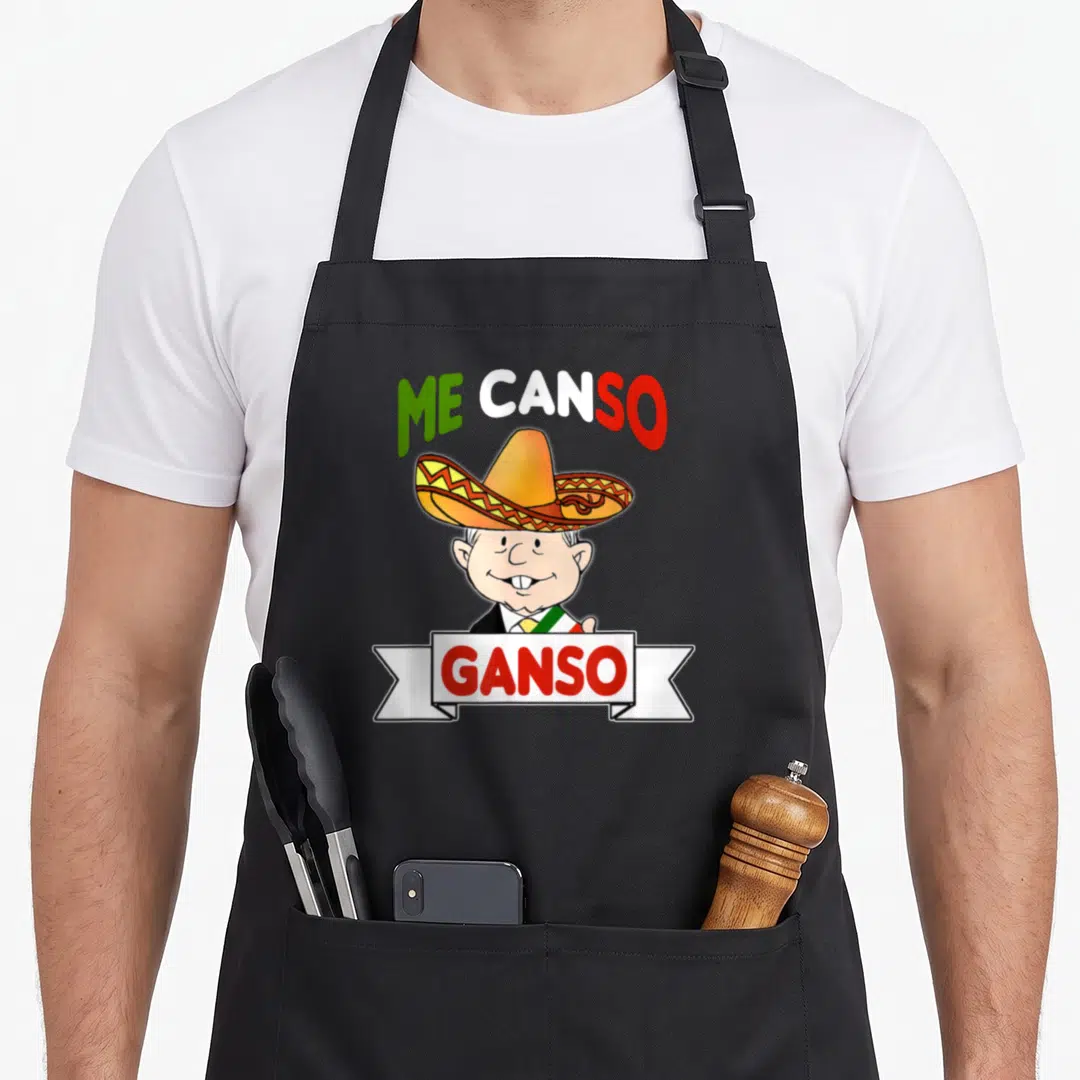 Canso mexico apron - Cartoon man in sombrero with ME CANSO GANSO text in green white and red — shown on a black cotton canvas apron against a white background