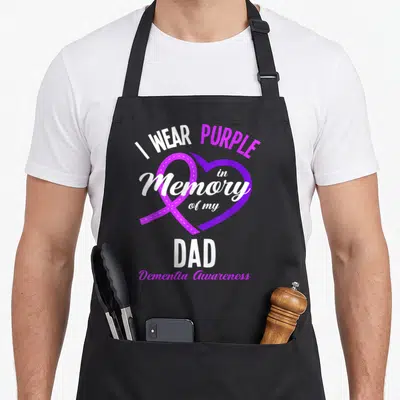 Dementia memory apron - Purple heart ribbon with I WEAR PURPLE in Memory of my DAD Dementia Awareness text — shown on a black cotton canvas apron against a white background