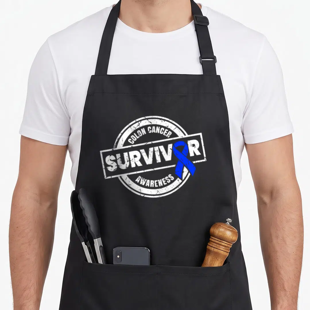Colon cancer girl apron - Distressed stamp design with blue ribbon and white text reading Colon Cancer Survivor — shown on a black cotton canvas apron against a white background