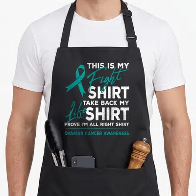 Fight ovarian ribbon apron - Teal ribbon and stacked white text reading This Is My Fight Shirt Ovarian Cancer Awareness — shown on a black cotton canvas apron against a white background