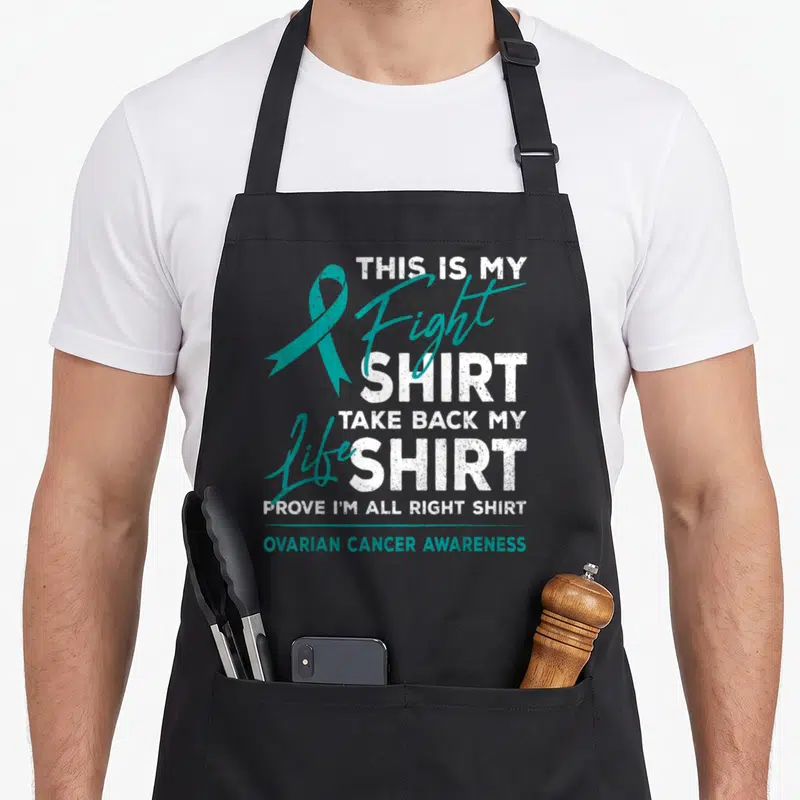 Fight ovarian ribbon apron - Teal ribbon and stacked white text reading This Is My Fight Shirt Ovarian Cancer Awareness — shown on a black cotton canvas apron against a white background