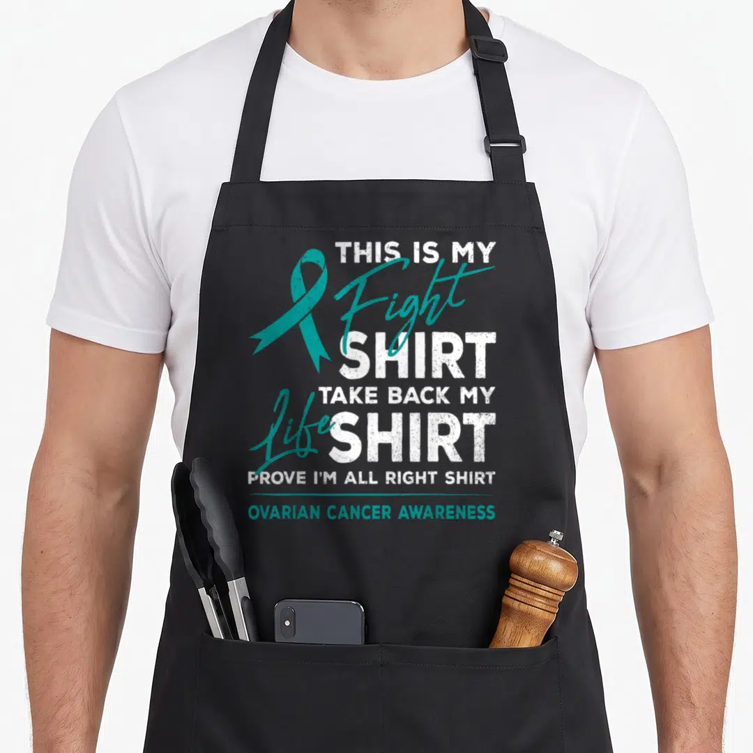 Fight ovarian ribbon apron - Teal ribbon and stacked white text reading This Is My Fight Shirt Ovarian Cancer Awareness — shown on a black cotton canvas apron against a white background