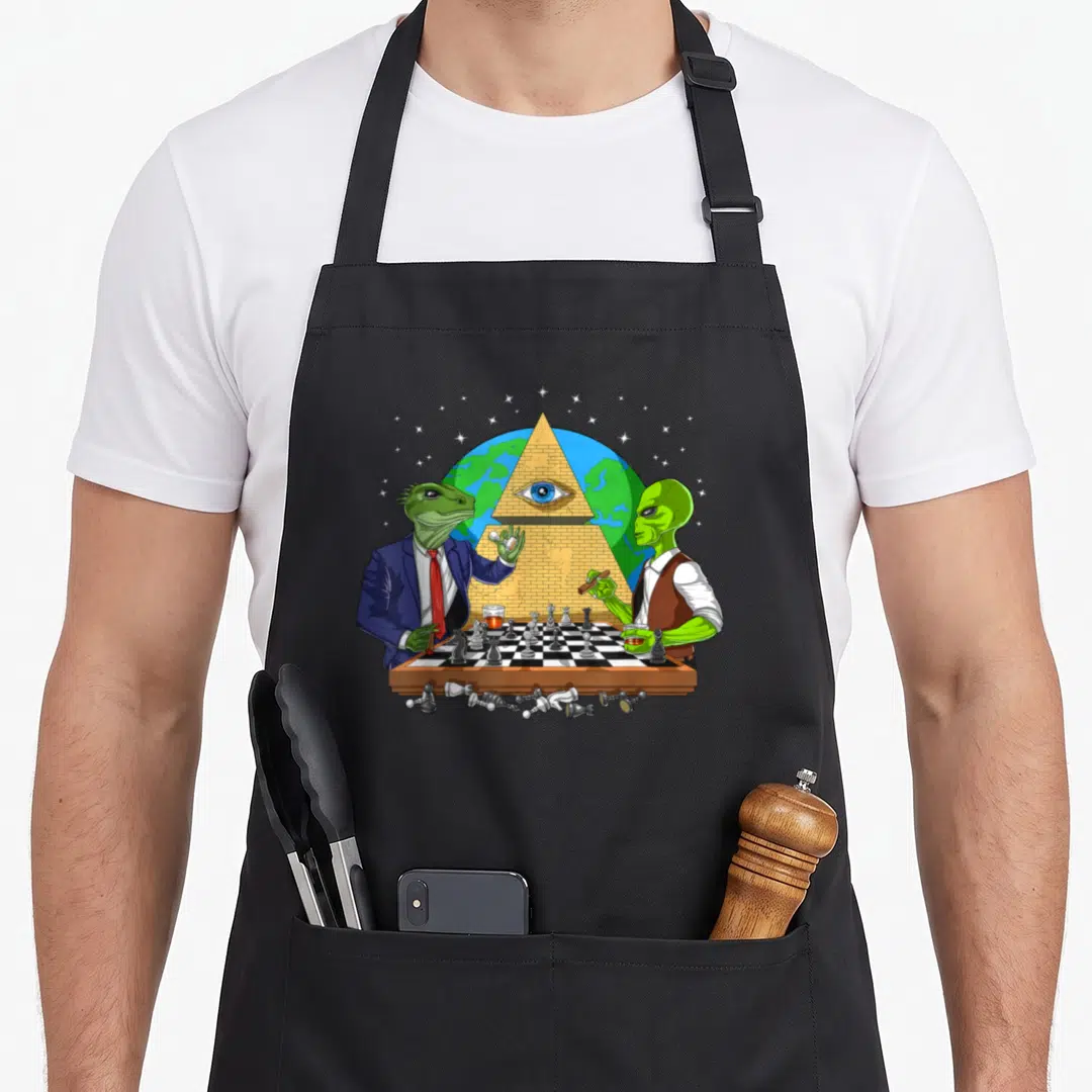 Alien masonic apron - Lizard man in suit and alien in vest playing chess before a gold pyramid with an eye over a globe — shown on a black cotton canvas apron against a white background
