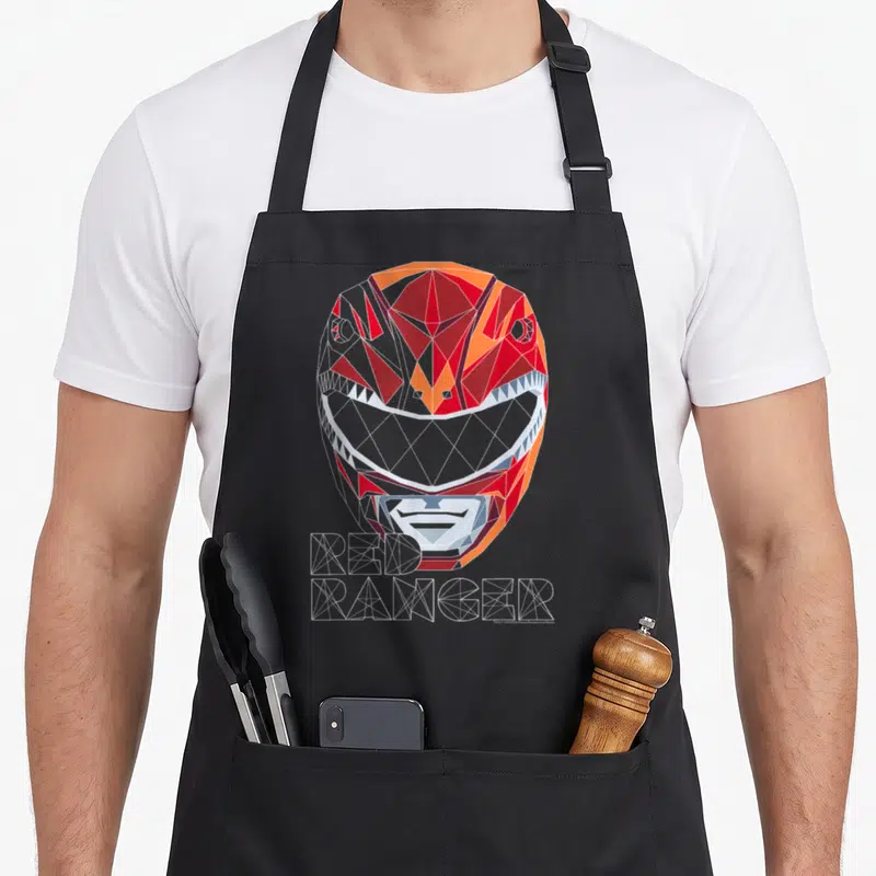 Geometric face apron - Low poly red ranger helmet with wireframe text in red orange white grey — shown on a black cotton canvas apron against a white background