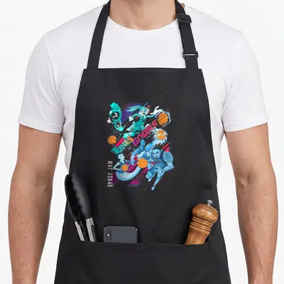 Legacy jam apron - Space Jam Tunes Goons cartoon group shot with basketballs and vertical text in cyan blue orange — shown on a black cotton canvas apron against a white background