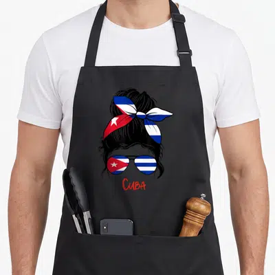 Cuba cuban girl apron - Black silhouette woman with flag headband and sunglasses above red CUBA text — shown on a black cotton canvas apron against a white background