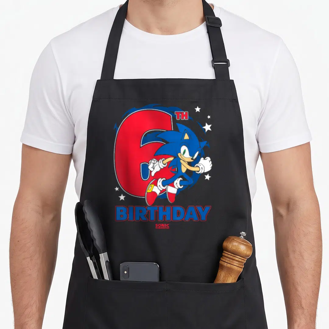 Epic 6th birthday apron - Sonic the Hedgehog leaping in front of a large red number 6 with BIRTHDAY text — shown on a black cotton canvas apron against a white background