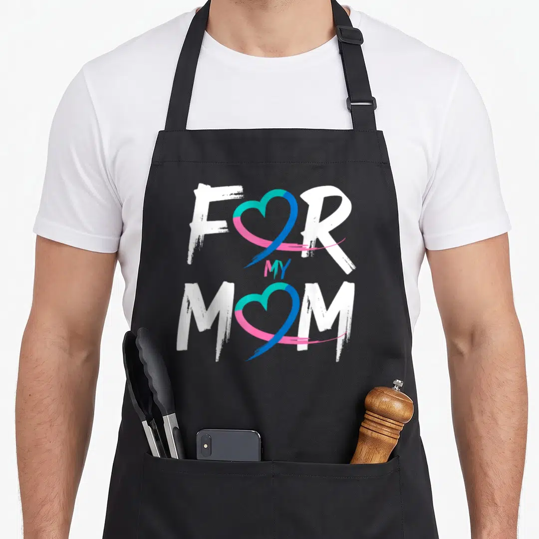 Funny cancer thyroid apron - FOR MY MOM text with blue pink and teal heart ribbons replacing O letters — shown on a black cotton canvas apron against a white background