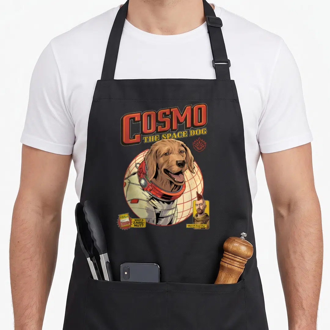 Guardian dog apron - Cosmo space dog in suit with want a zarg nut text and man portrait — shown on a black cotton canvas apron against a white background