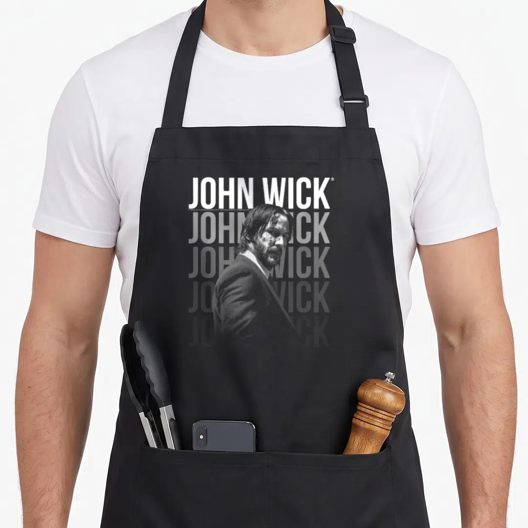 John crew apron - Man in suit photo overlapping three lines of JOHN WICK text in grey and white — shown on a black cotton canvas apron against a white background