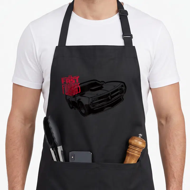 Fast muscle apron - Black and white muscle car drawing with red distressed FAST FURIOUS text overlay — shown on a black cotton canvas apron against a white background