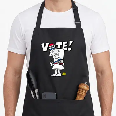 Vote schoolhouse rock apron - Standing cartoon paper bill wearing hat and buttons under VOTE! text — shown on a black cotton canvas apron against a white background