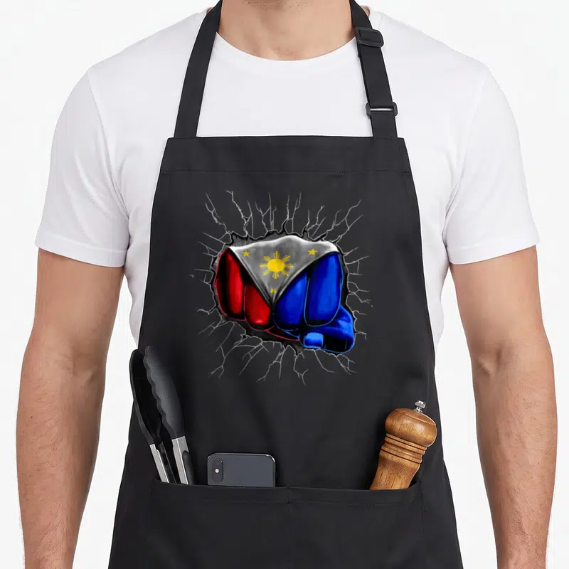 Philippine filipino girl apron - Fist painted in blue red white and yellow flag colors punching through grey surface — shown on a black cotton canvas apron against a white background