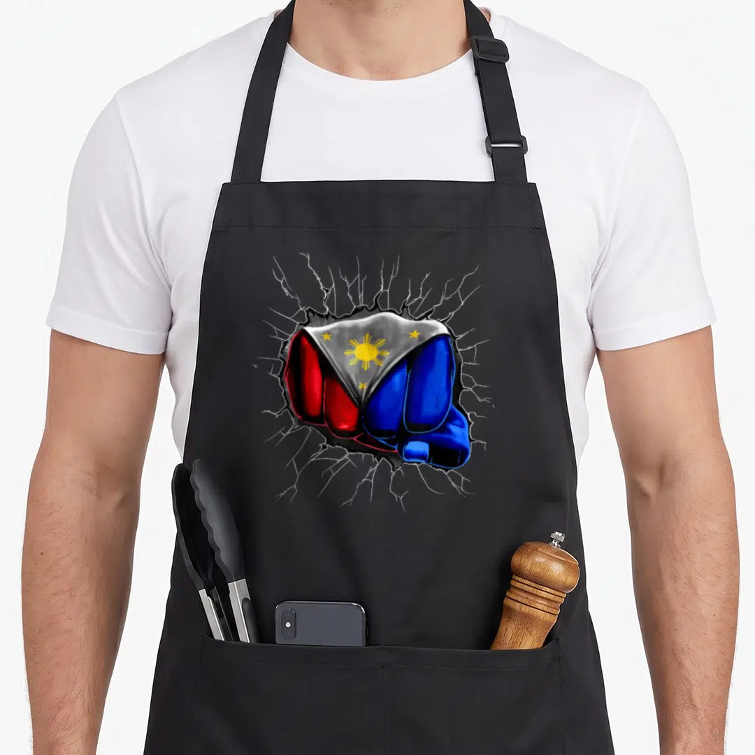 Philippine filipino girl apron - Fist painted in blue red white and yellow flag colors punching through grey surface — shown on a black cotton canvas apron against a white background