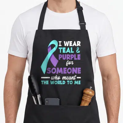 Someone depression awareness apron - Teal and purple ribbon next to text I wear teal and purple for someone who meant — shown on a black cotton canvas apron against a white background
