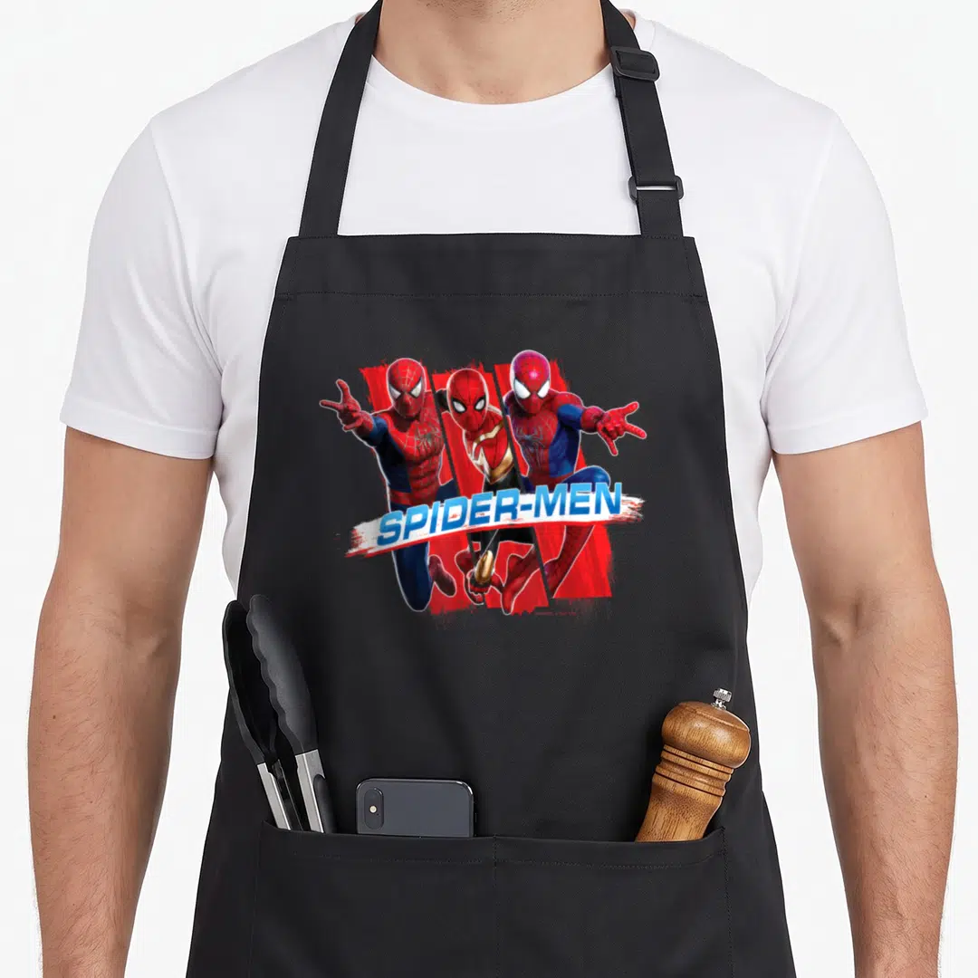 Trio novelty apron - Three Spider-Men in red blue white with SPIDER-MEN banner — shown on a black cotton canvas apron against a white background