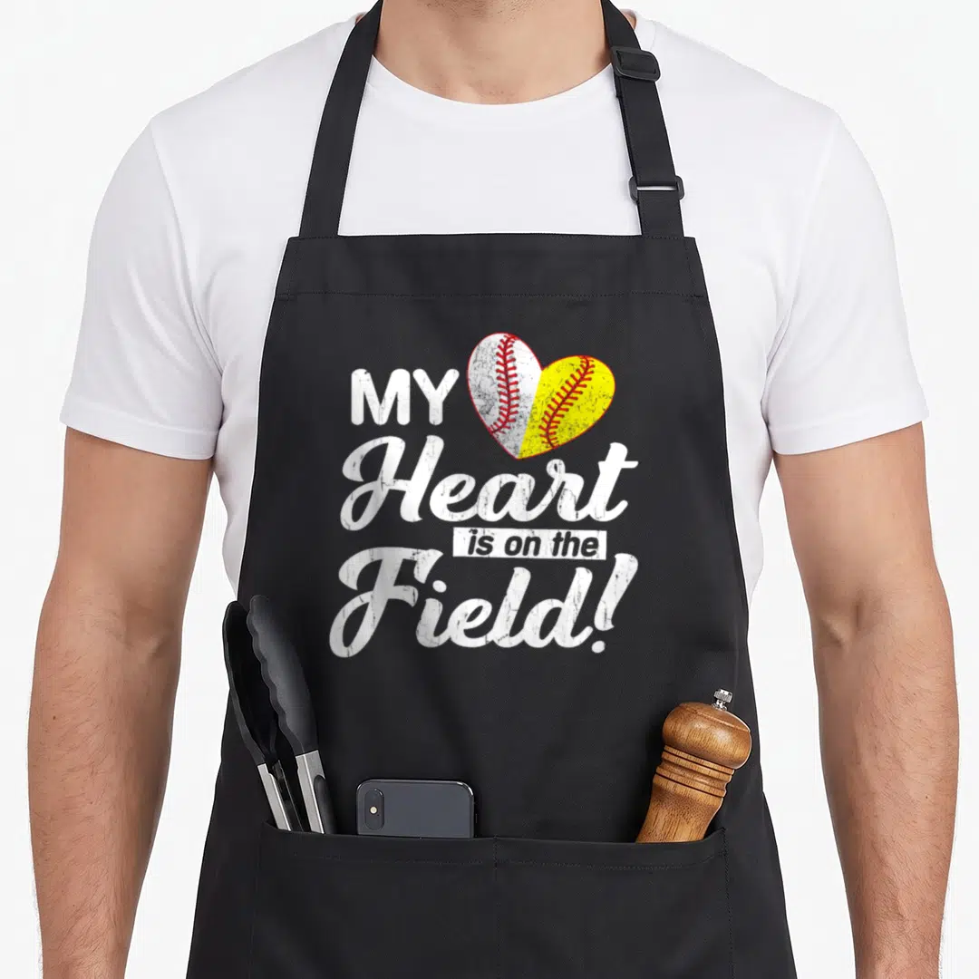 Field baseball mother's day aprons - Split heart baseball softball graphic with distressed white and yellow text — shown on a black cotton canvas apron against a white background