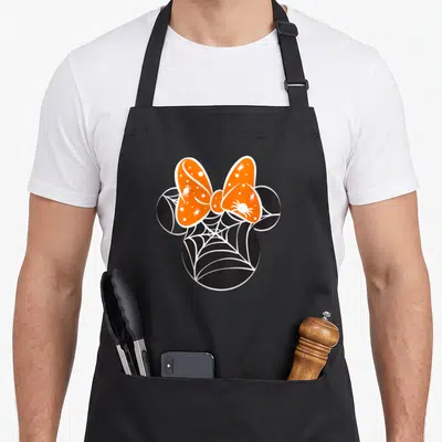 Friend spider halloween apron - Black mouse head silhouette with white spider web pattern and orange bow containing — shown on a black cotton canvas apron against a white background