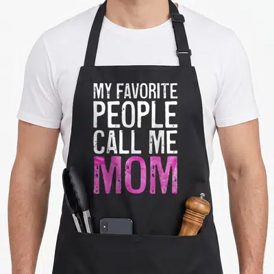 Funny call mother's day aprons - Stacked text reading My Favorite People Call Me Mom in white and pink distressed fonts — shown on a black cotton canvas apron against a white background