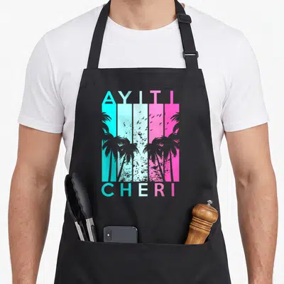 Haiti haitian girl apron - Retro Ayiti Cheri text with cyan pink grey palm tree stripes — shown on a black cotton canvas apron against a white background