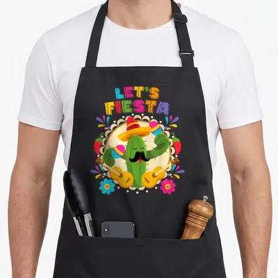 Fiesta cactus apron - Arched LET'S FIESTA text over cactus with sombrero holding two guitars amidst maracas and chilies — shown on a black cotton canvas apron against a white background