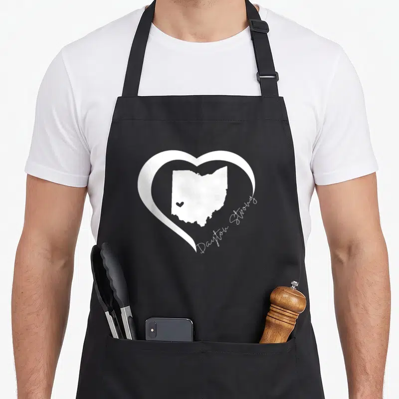 Dayton ohio boy apron - White heart outline enclosing Ohio map with Dayton Strong script text — shown on a black cotton canvas apron against a white background