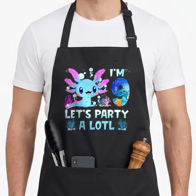 Alotl kawaii apron - Cartoon blue axolotl with pink gills and text I'M 9 LET'S PARTY A LOTL — shown on a black cotton canvas apron against a white background