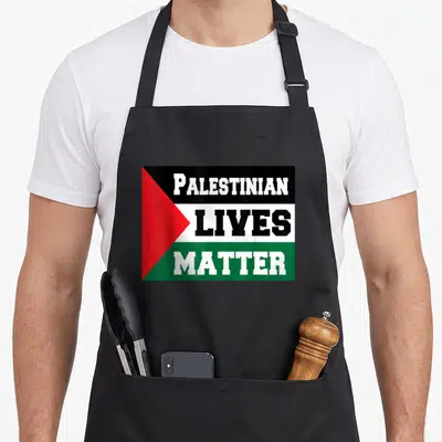 Live palestinian apron - PALESTINIAN LIVES MATTER text on black white green red flag stripes — shown on a black cotton canvas apron against a white background