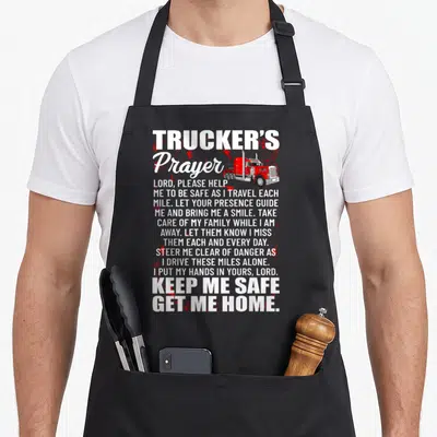 Prayer semi truck apron - Trucker's Prayer text with red semi-truck and distressed splatters — shown on a black cotton canvas apron against a white background