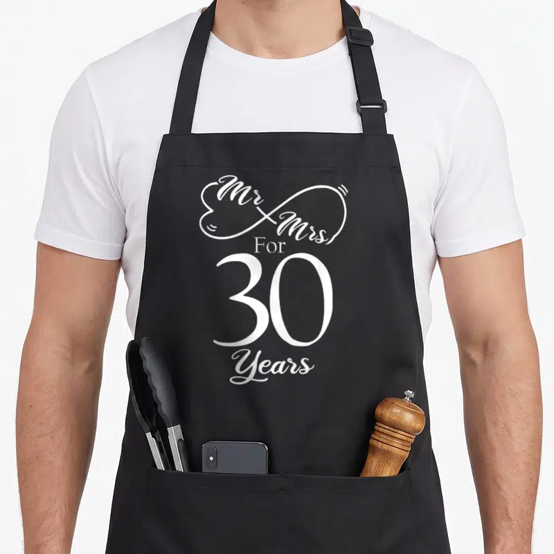 30th mr mrs aprons - White Mr & Mrs For 30 Years text inside infinity heart shape — shown on a black cotton canvas apron against a white background