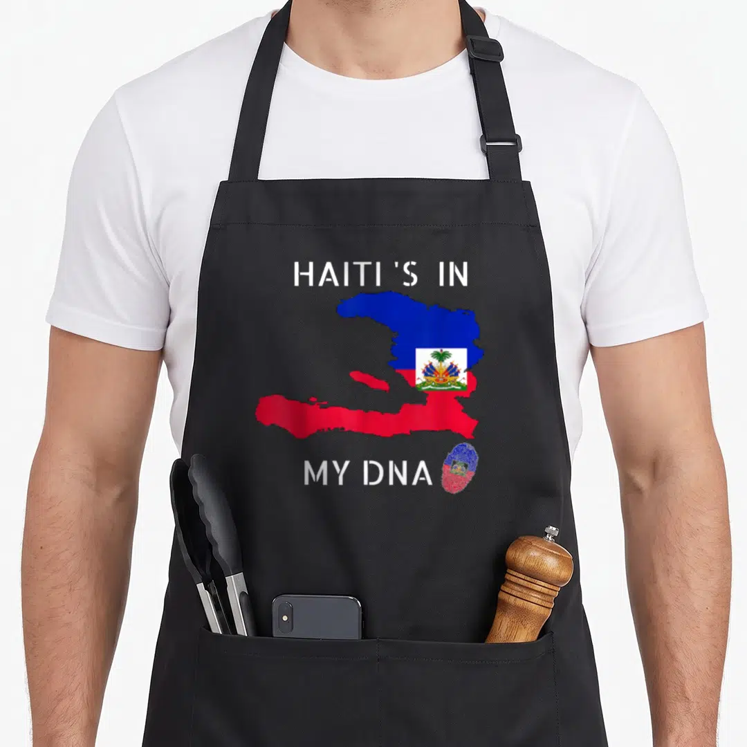 Dna haitian pride apron - Map of Haiti filled with white blue red flag colors next to a matching fingerprint and text — shown on a black cotton canvas apron against a white background