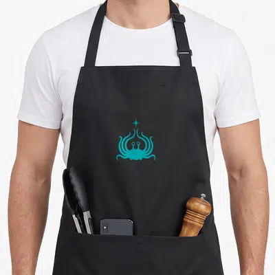 Spaghetti monster flying apron - Teal stylized octopus with four-pointed star above head, minimalist art style — shown on a black cotton canvas apron against a white background