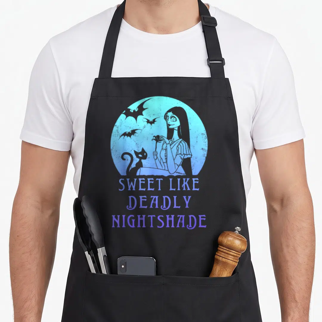 Sally meh apron - Blue circle with woman cat bats and text Sweet Like Deadly Nightshade — shown on a black cotton canvas apron against a white background